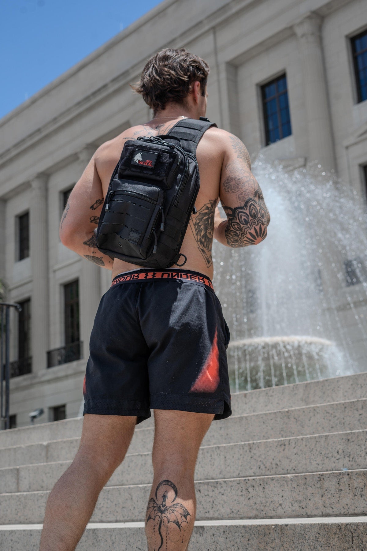 Compact sling bag worn crossbody downtown