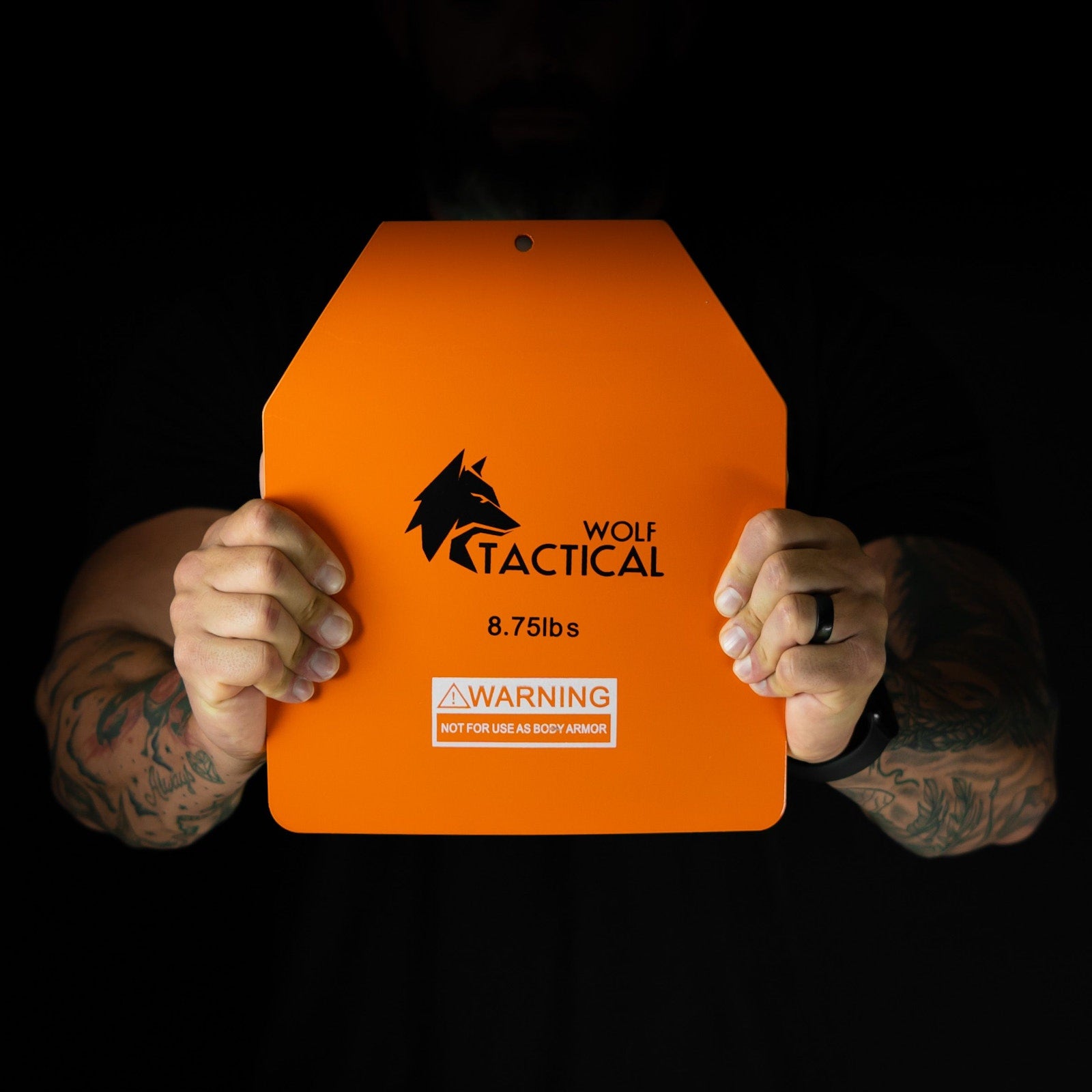 Holding an orange Wolf curved steel plate