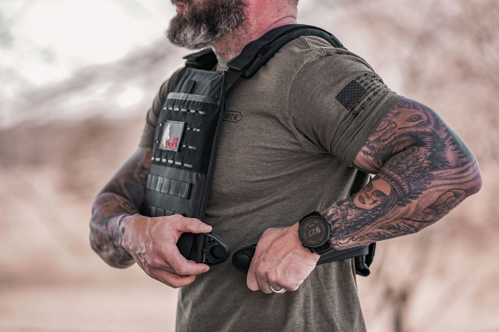 Cinching the metal side buckle of the Wolf Quick-Release weighted vest