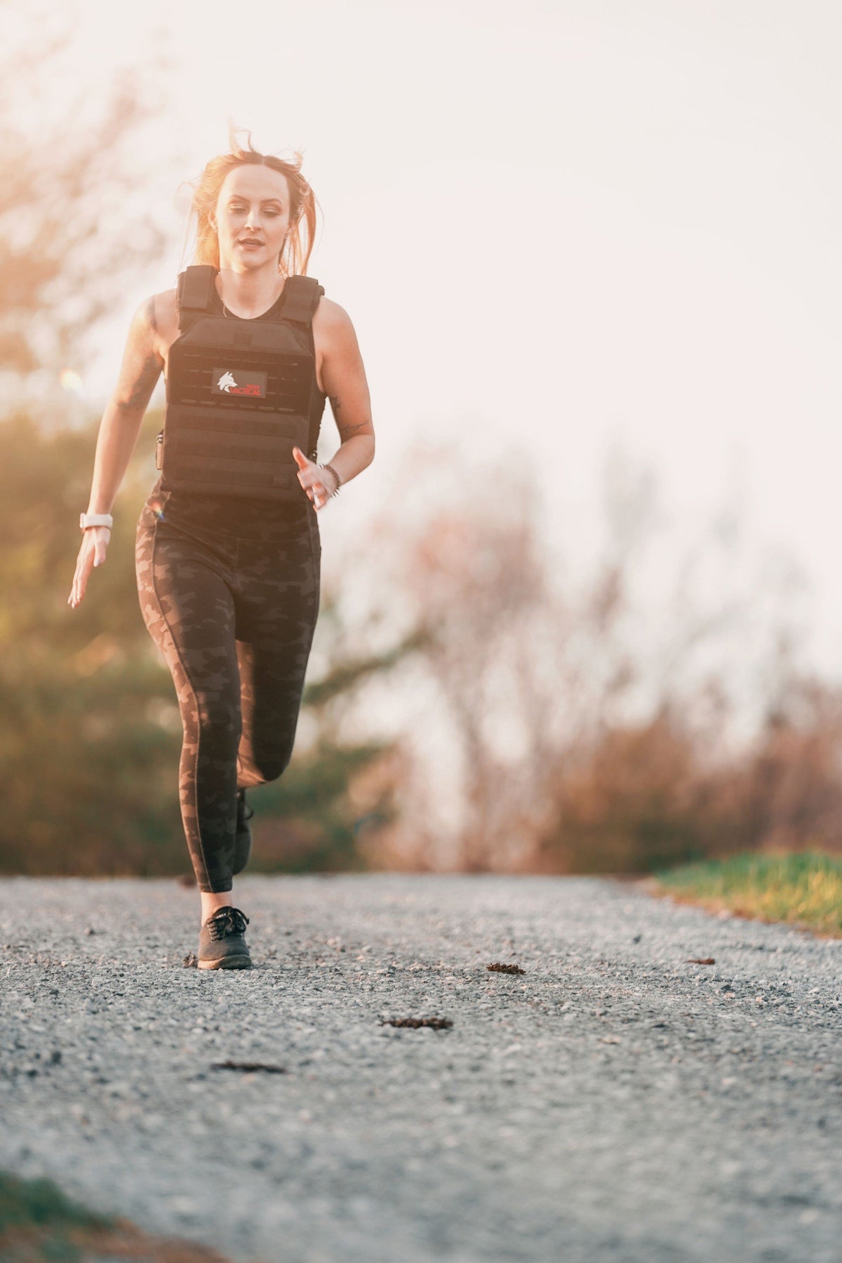 Woman on a country road in the Wolf Simple weighted vest